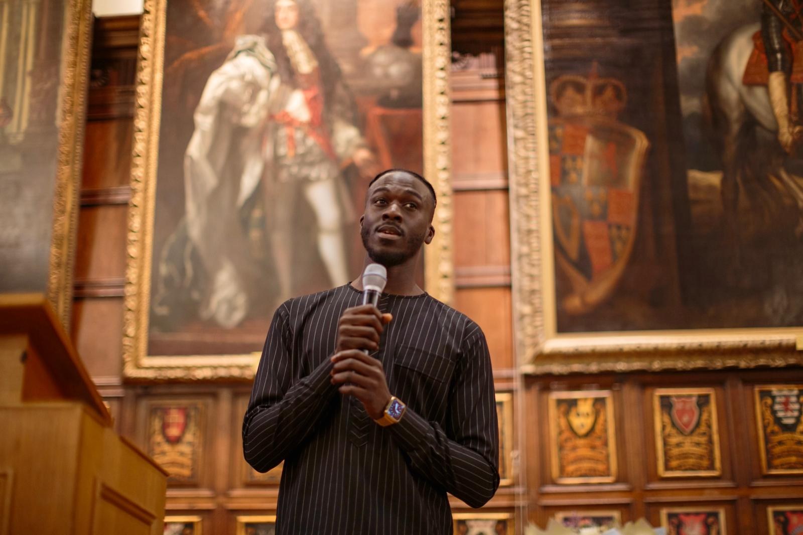 Mass Ndow-Njie speaking at a formal legal event